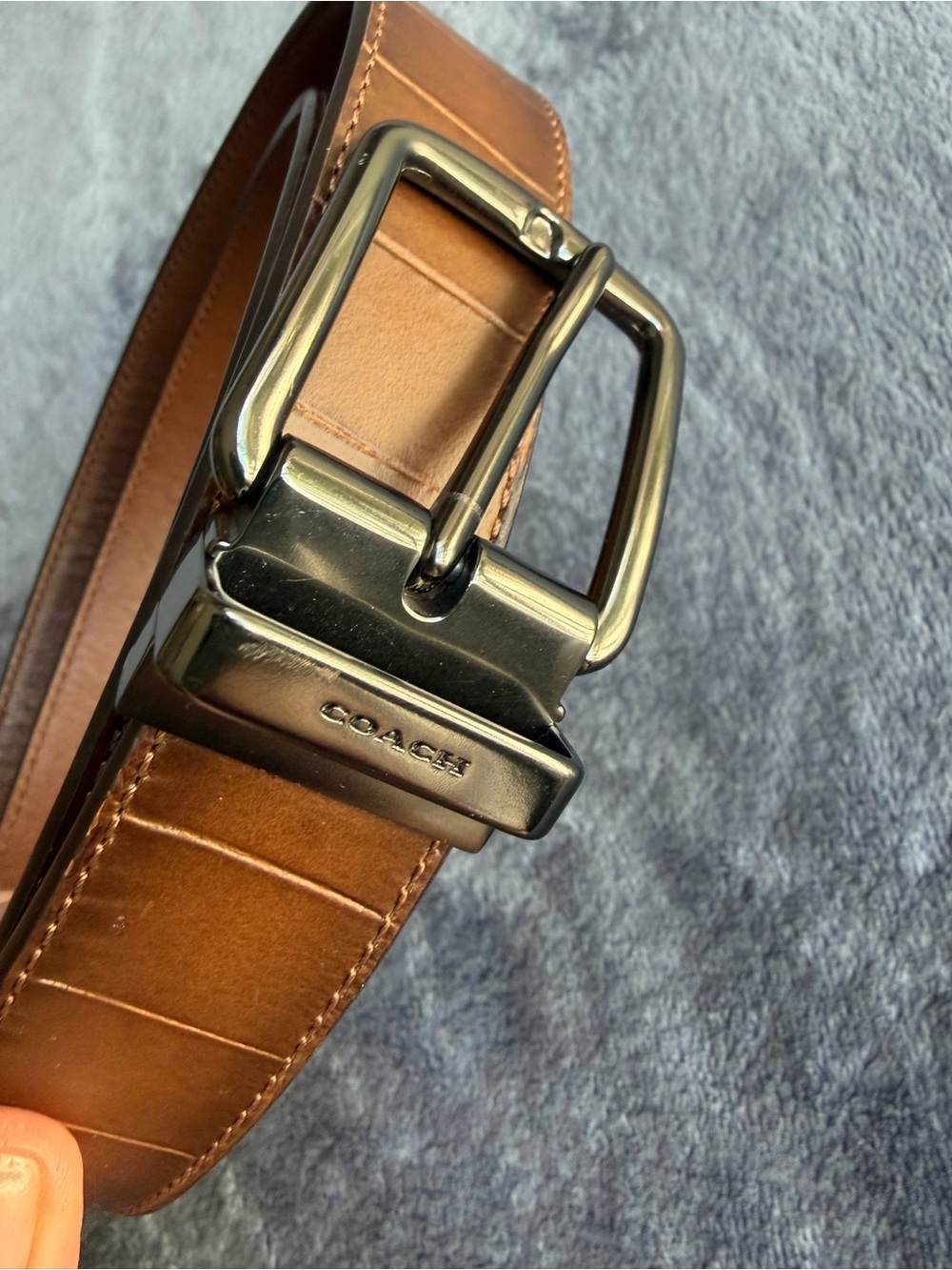 Coach harness buckle belt in a brown leather finish.